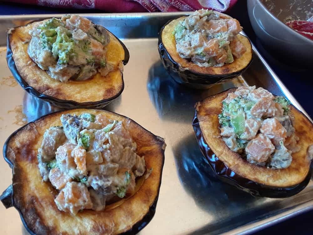 The acorn squash is filled with the creamy sauteed vegetables.