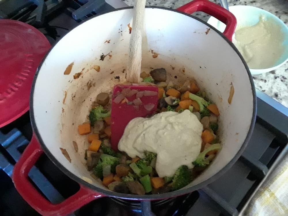 The cream is added into the sauteed vegetables.