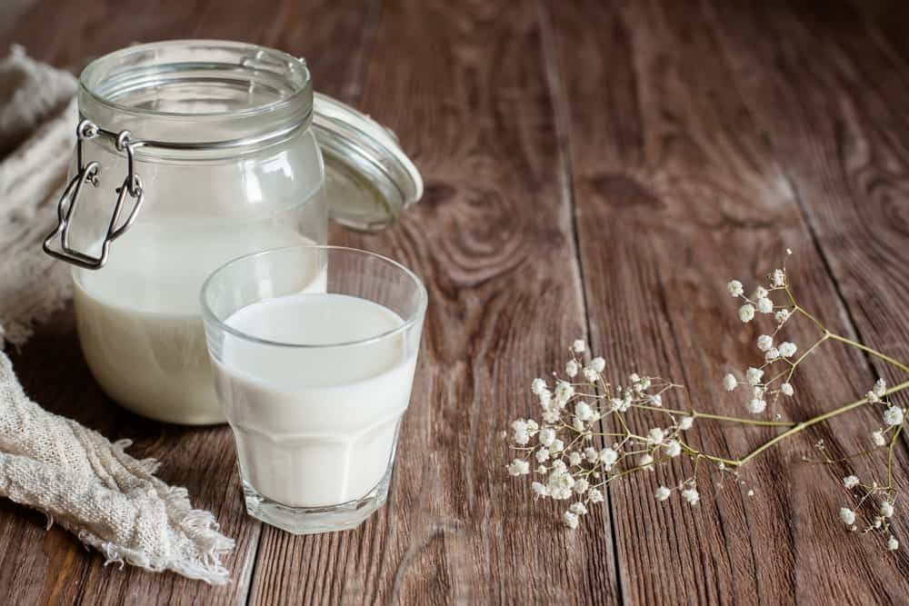 A jar and a glass of full cream milk.
