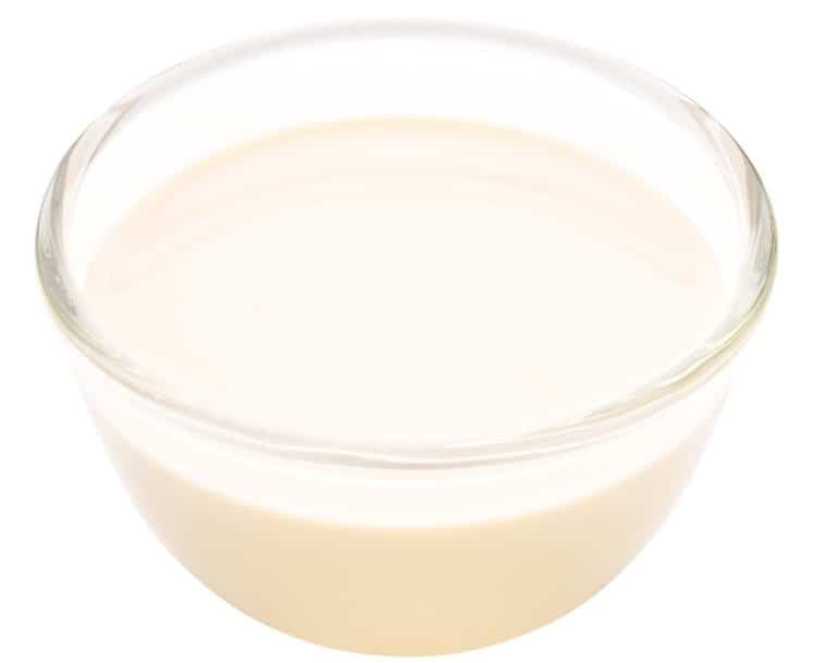 A glass bowl of evaporated milk.