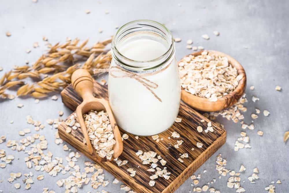 A large jar filled with oat milk.