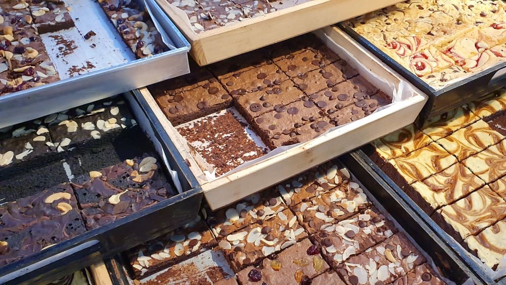Different types of brownies on display at a store.