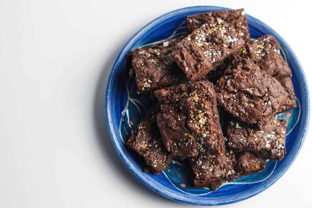A plate of chocolate brownies topped with sea salt.