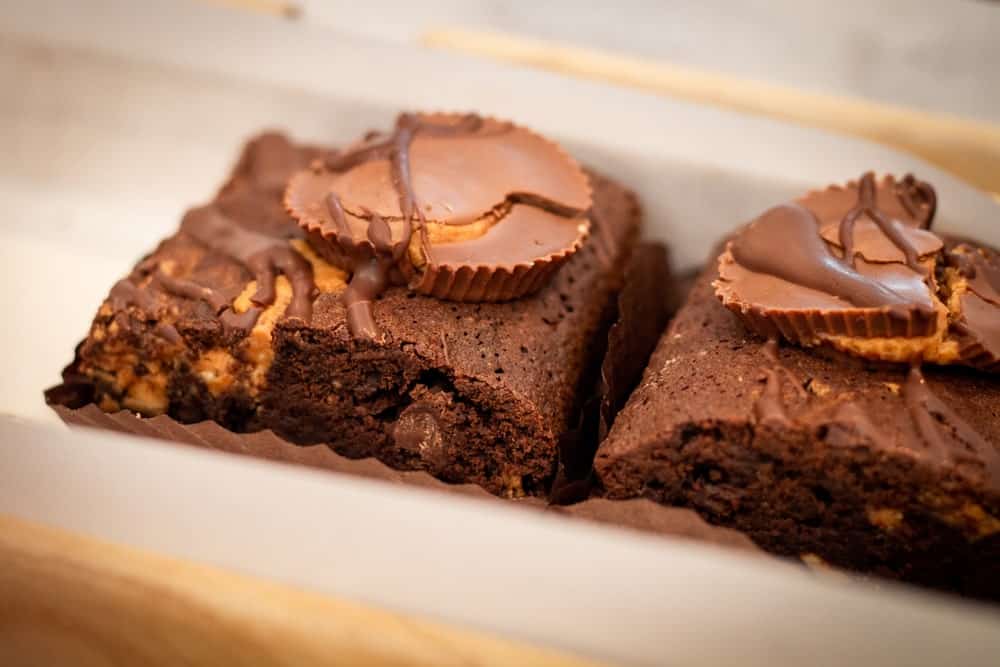 A couple of brownies topped with Reese's peanut butter cups.