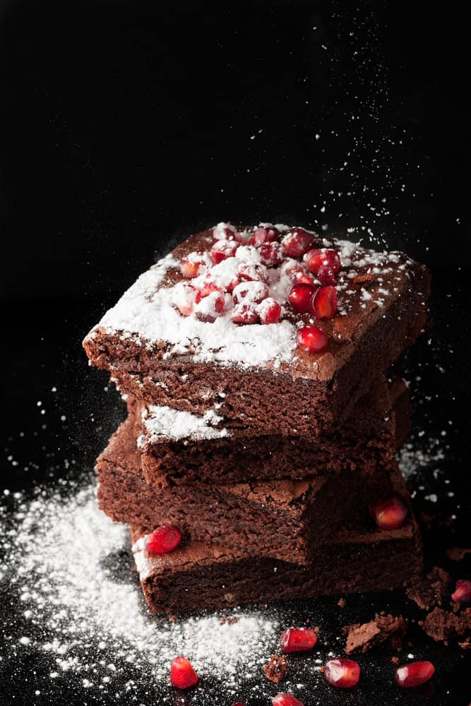 A stack of dark chocolate pomegranate brownies.