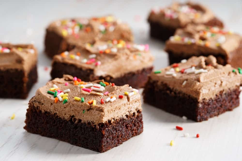 Chocolate fudge brownies with chocolate buttercream frosting and rainbow sprinkles.