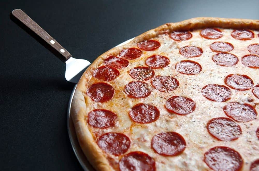 Pizza Spatula with a pepperoni pizza