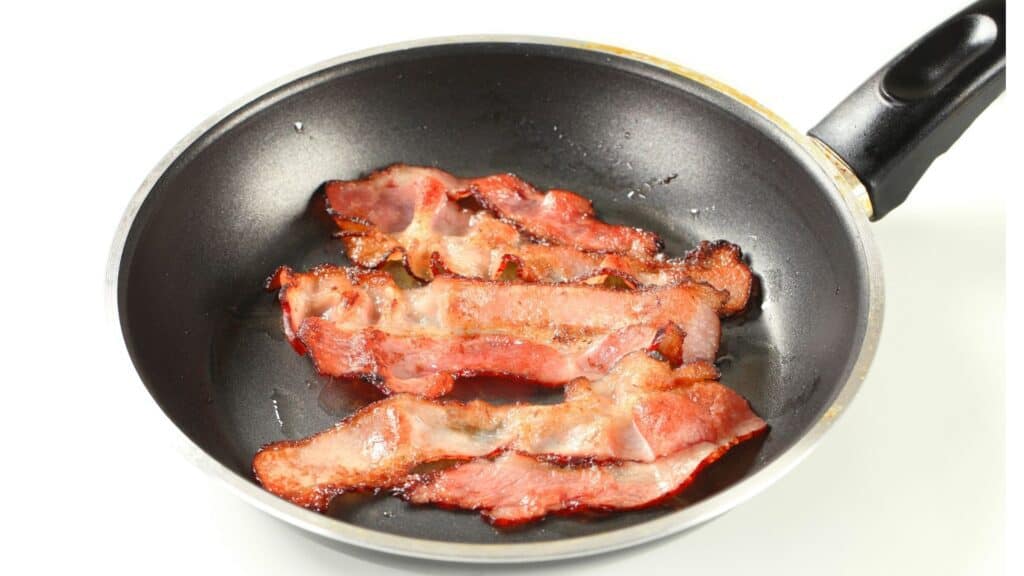 bacon cooking in a frying pan