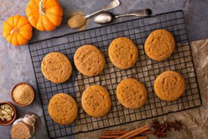 Pumpkin cookies on a cooling rack.