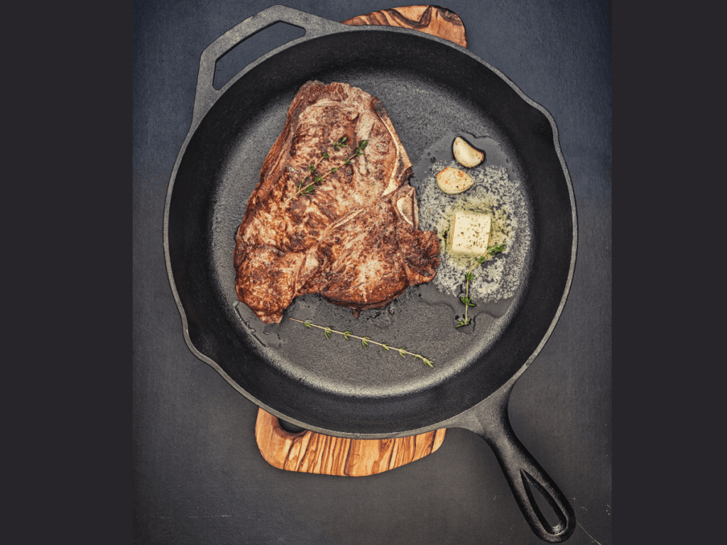 Steak cooked in a cast iron skillet with butter