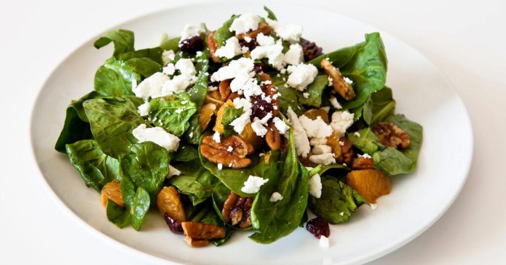 Plate of Spinach Salad  with feta cheese and walnuts