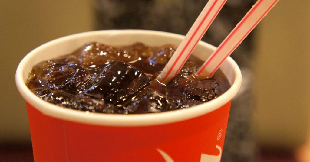 Paper cup of Diet Coke with two straws