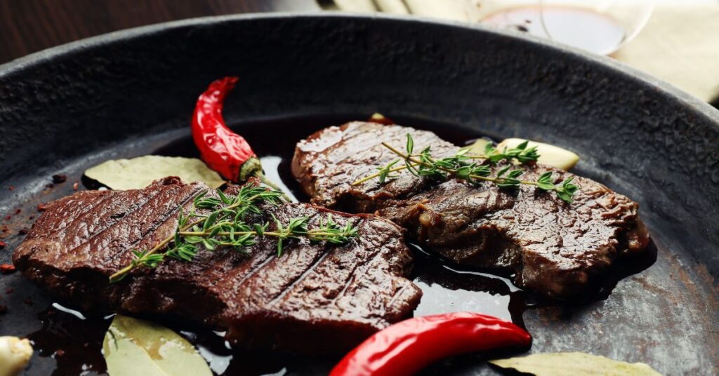 steak cooked on the stove with butter