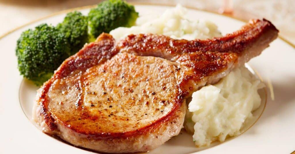 cooked pork chops with broccoli and mashed potatoes
