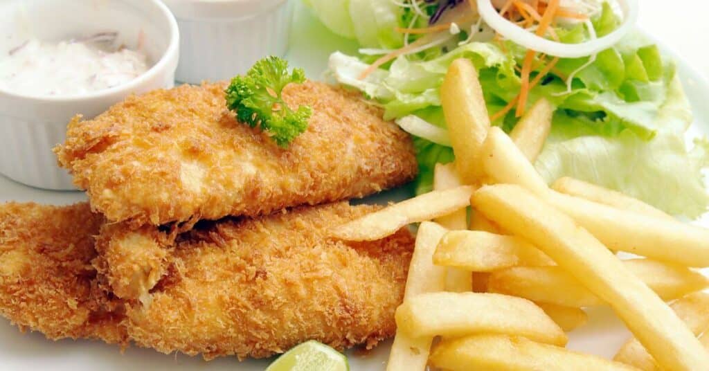 fried fish with French fries and salad