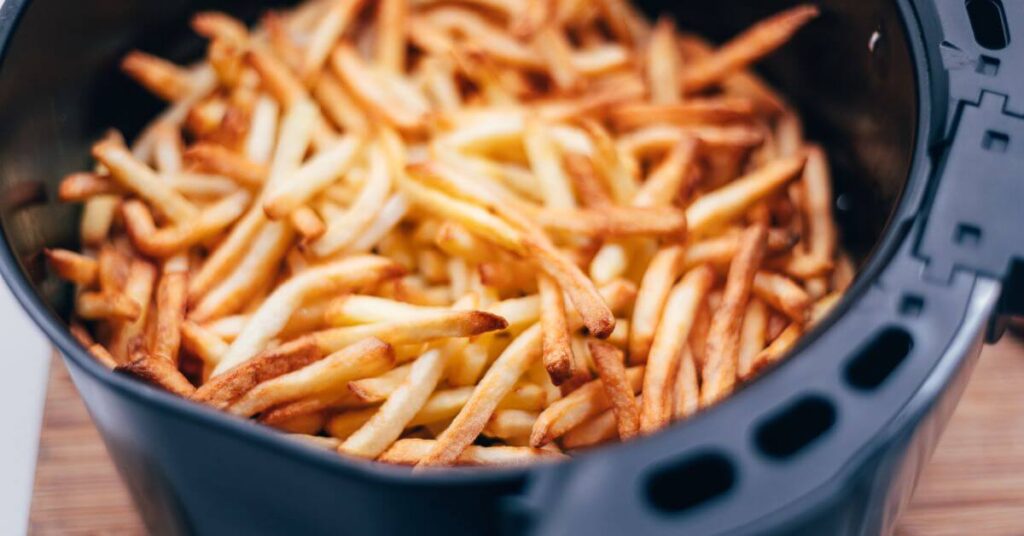 french fries being cooked in an air fryer