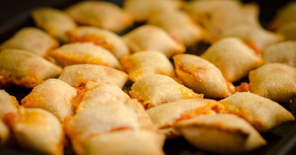 a bunch of cooked pizza rolls 