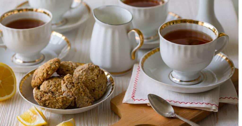 Cups of Irish Breakfast Tea and English Breakfast Tea along with a plate of cookies