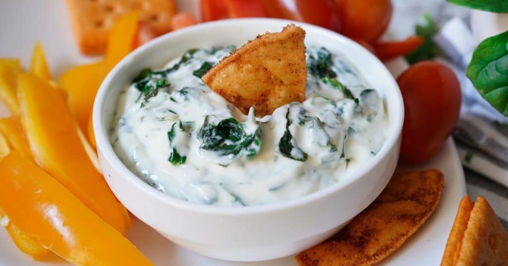 spinach dip with cut raw vegetables