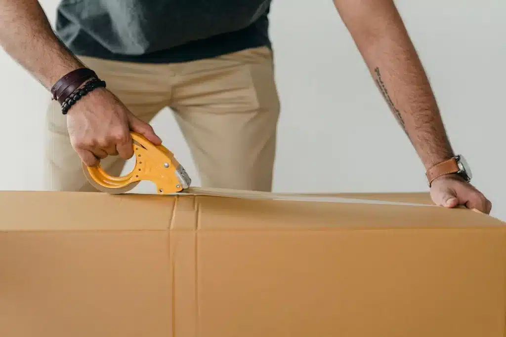 Man packing a box preparing to move to a new home