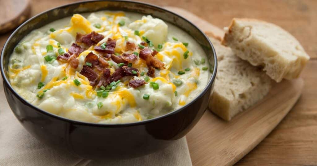 bowl of potato soup with a side of bread