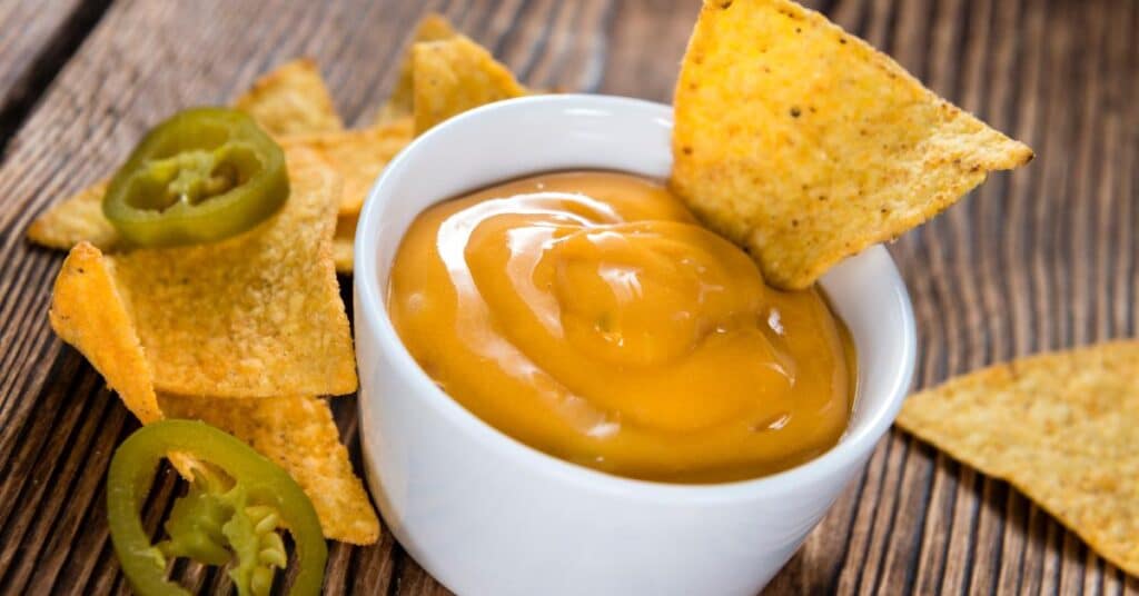 nacho cheese dip with chips and jalapeno