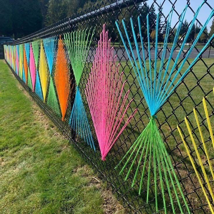 Vibrant Yarn Fence Weaving Art